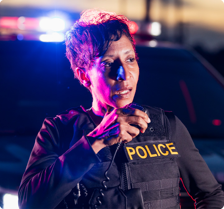 Female law enforcement speaking on mission-critical push-to-talk (MCPTT) device 